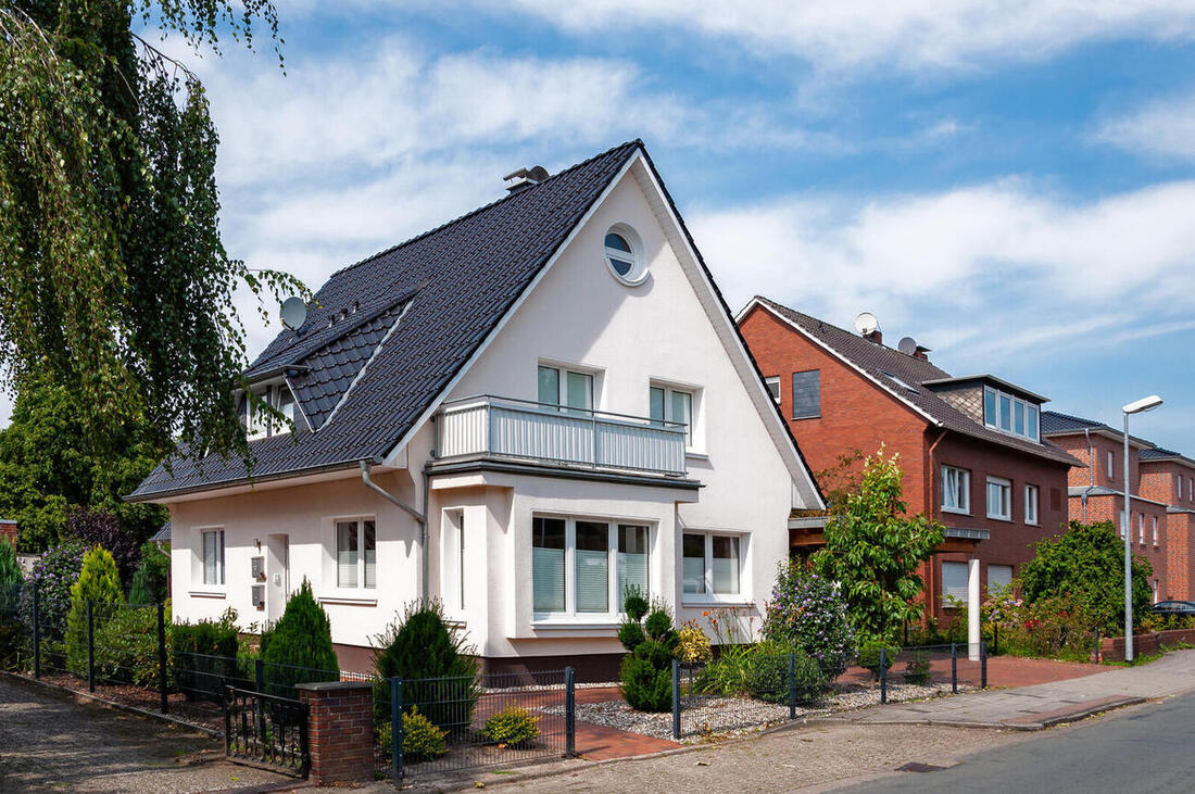 Einfamilienhaus mit gepflegtem Vorgarten und geschnittenen Hecken